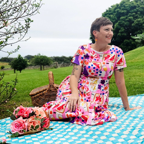 Showcasing a pink printed dress on a romantic picnic.