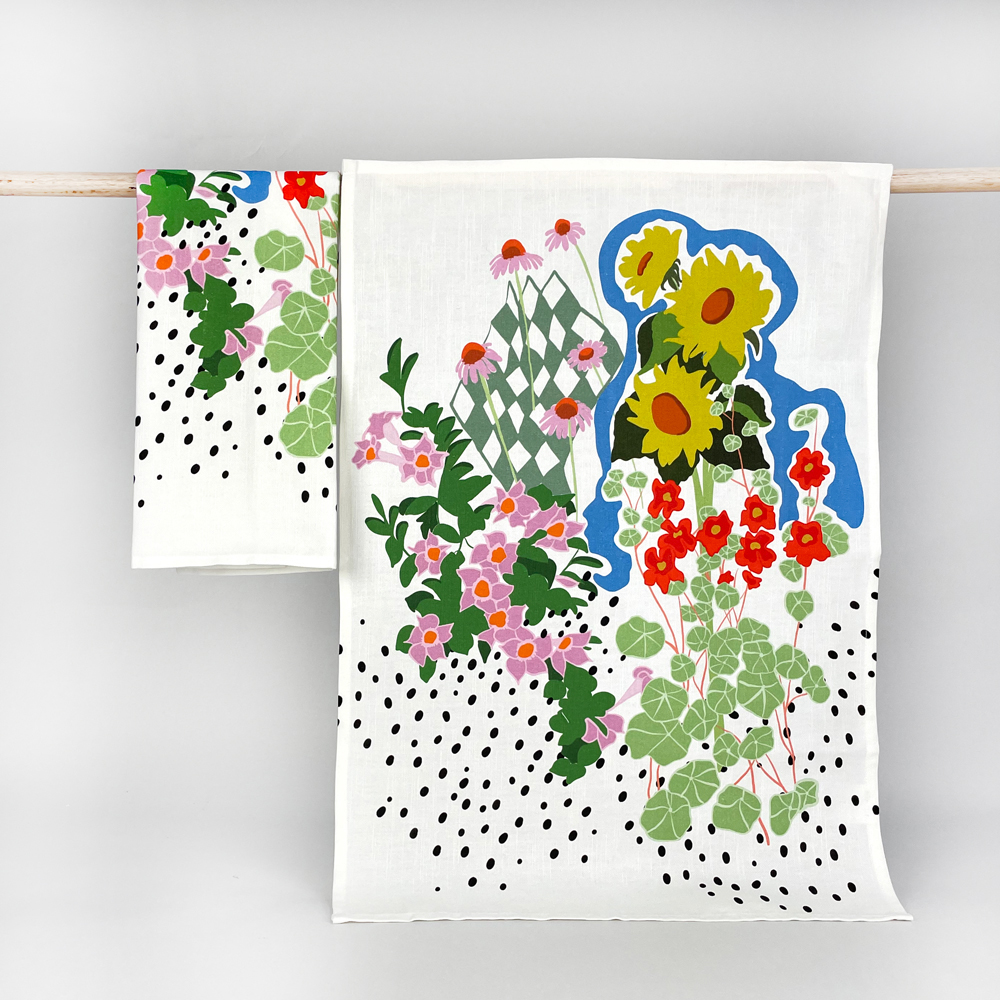 custom printed tea towel by next state hanging on a rod with a floral print