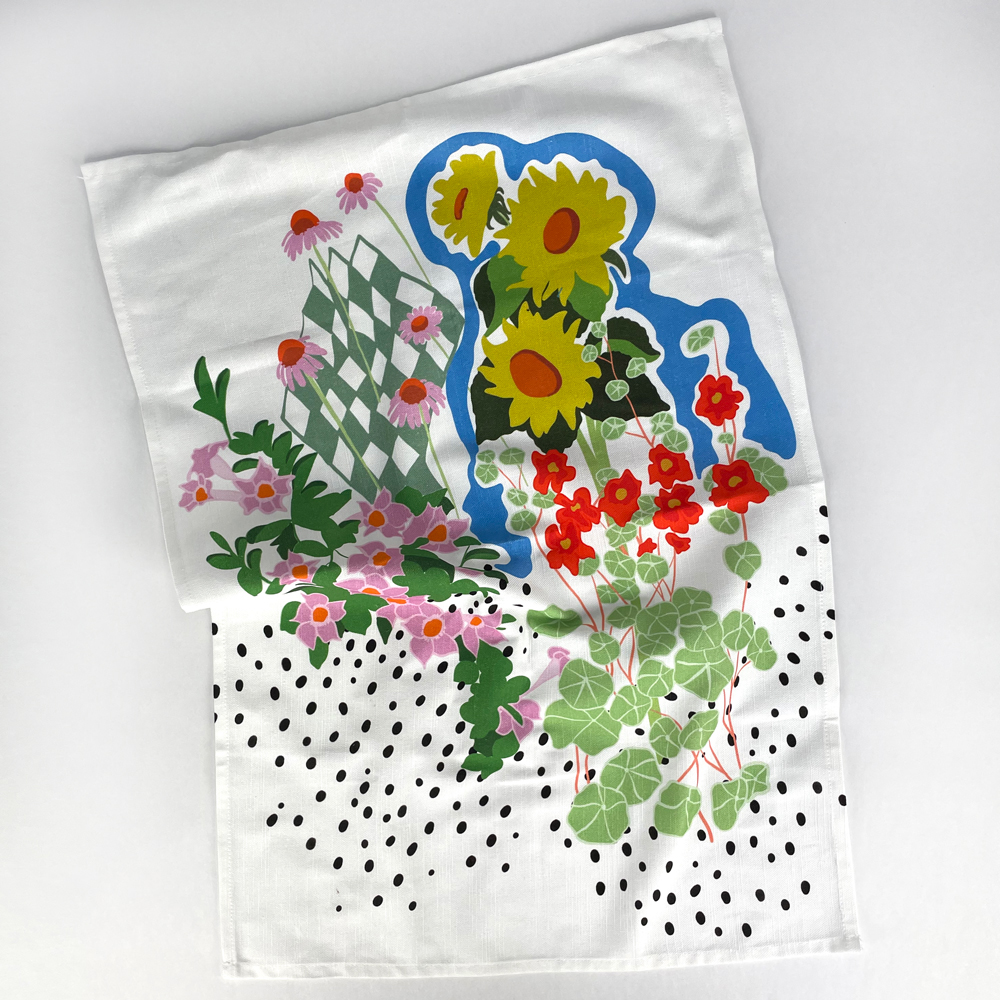 Image of a printed tea towel that has been custom printed laying flat with a floral print
