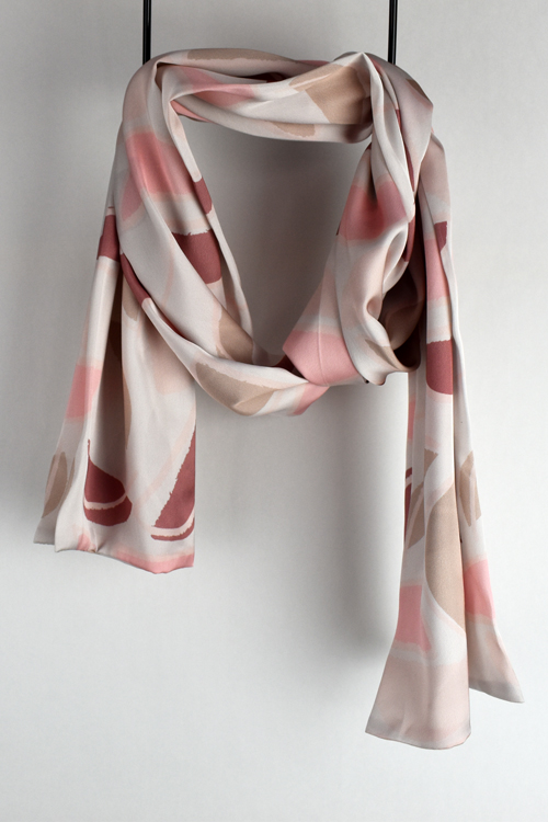 custom printed satin scarf draped against a wall